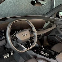 Ohjaamo: Car interior showing the steering wheel and dashboard