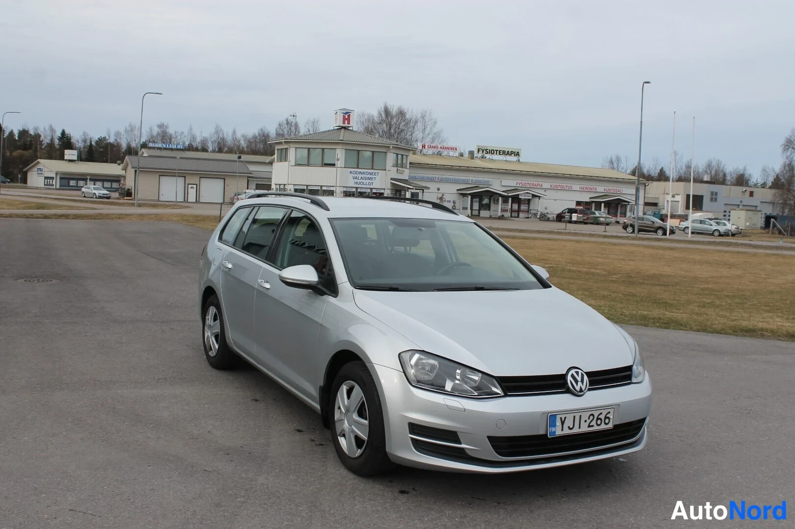 Etuviisto, nokka oikealle: Hopeinen farmariauto etuviistokuva; keula, VW-merkki, ajovalot ja rekisterikilpi näkyvät, kylki vasemmalla.