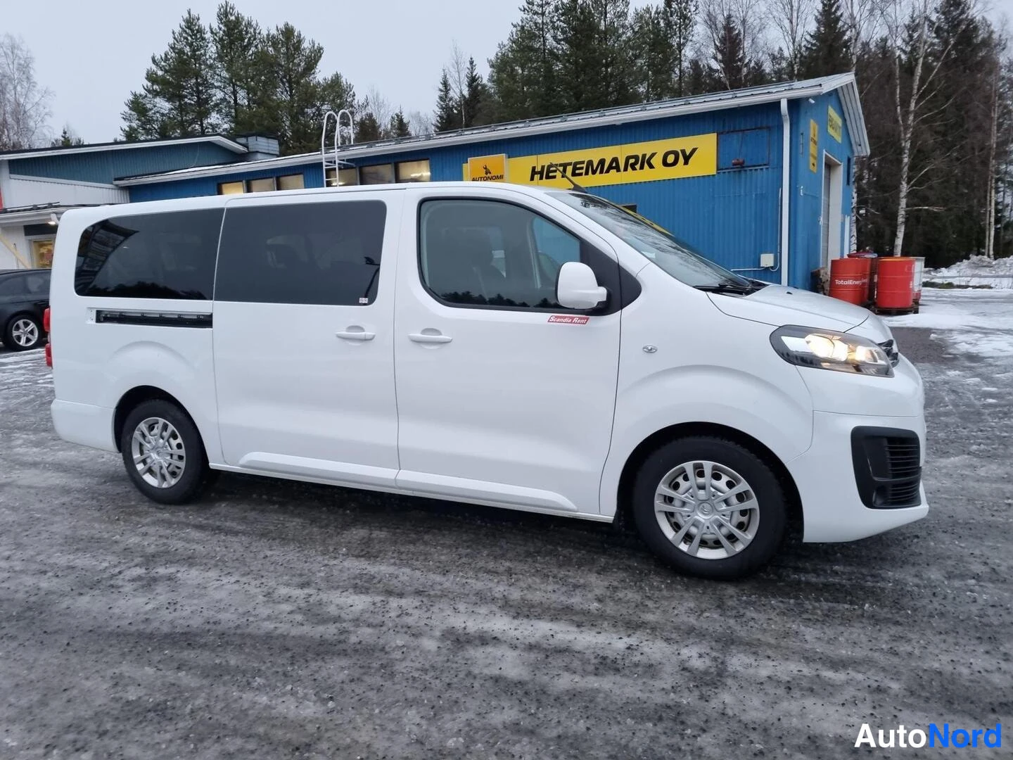 Etuviisto, nokka oikealle: Valkoinen Citroën -pakettiauto sivulta etukulmasta, kylki ja etupää näkyvissä.