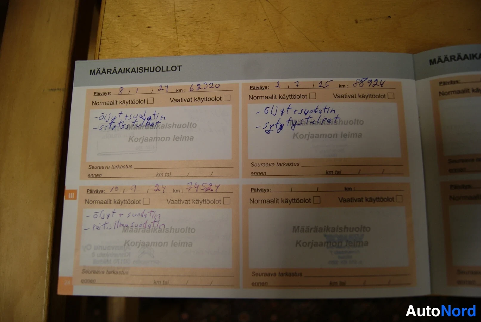 Muu: Avattu huoltokirja, jonka MÄÄRÄAIKAISHUOLLOT-sivuille on kirjoitettu päivämäärät, kilometrimäärät ja huoltomerkinnät.