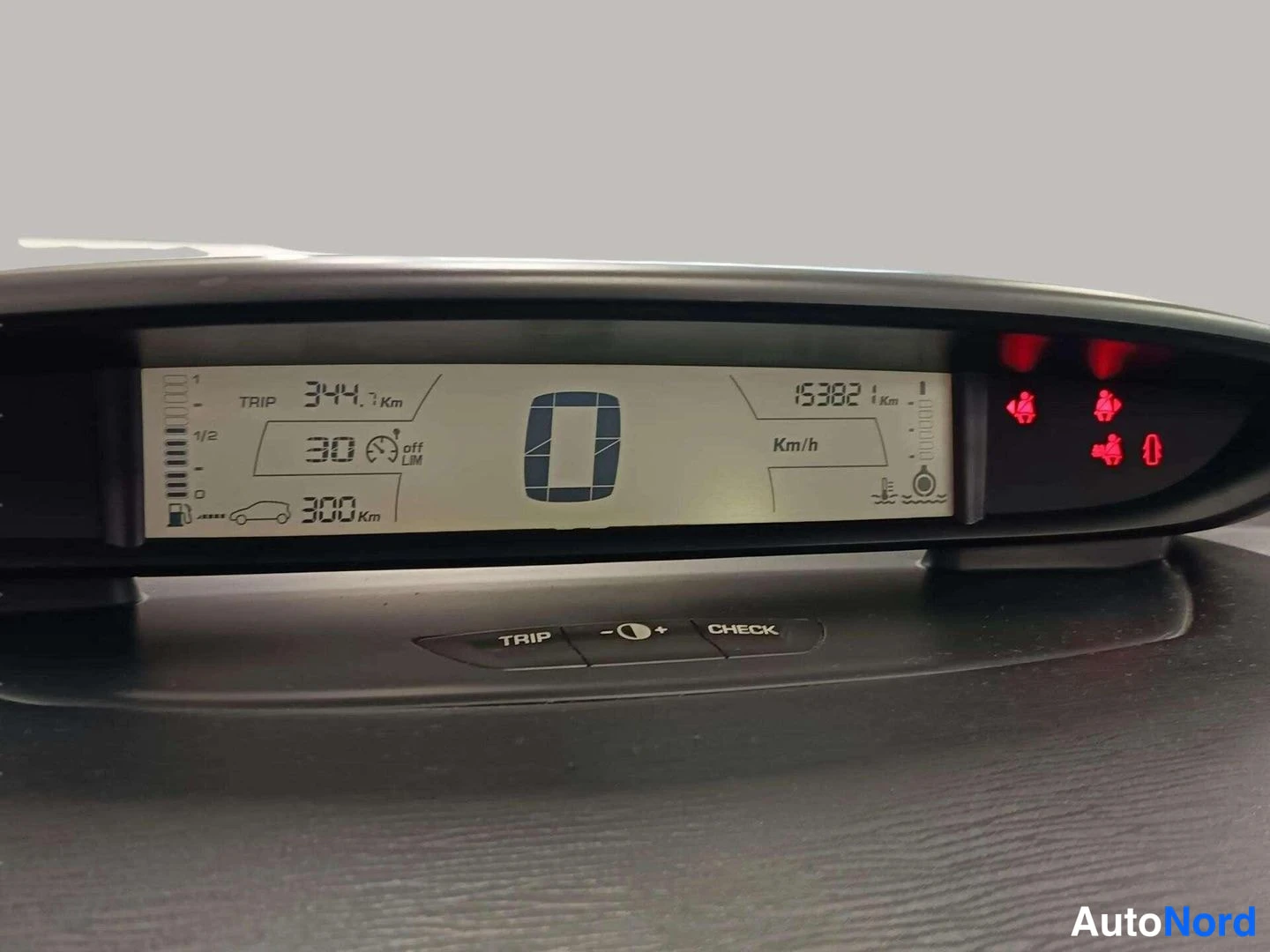 Muu: Citroënin hallintapaneelin näyttö, jossa näkyy matkamittari 153821 km, trip 344,7 km, nopeusrajoitinasetus 30 km/h ja palavia varoitusvaloja.