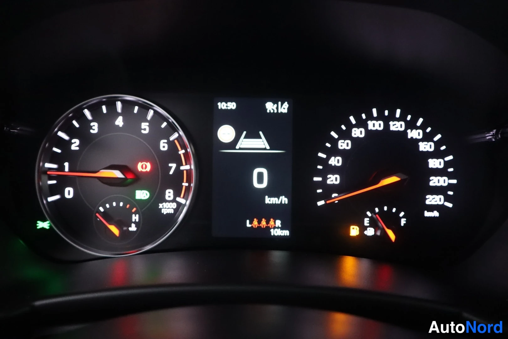 Muu: Mittaristö lähikuvassa: kierroslukumittari ja nopeusmittari sekä näyttö, jossa lukee 10:50, 0 km/h ja 10 km.