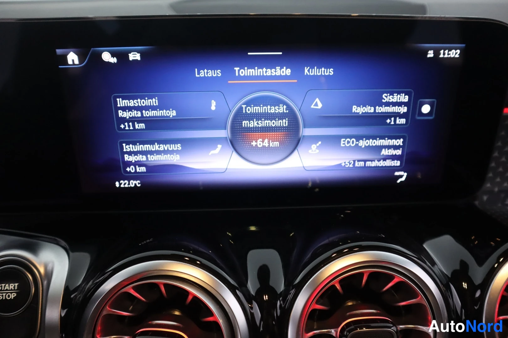 Muu: Toimintasäde-näkymä infotainment-näytöllä: toimintasäteen maksimointi +64 km, ilmastointi +11 km, istuinmukavuus +0 km, sisätila +1 km, ECO-ajo toiminnolla +52