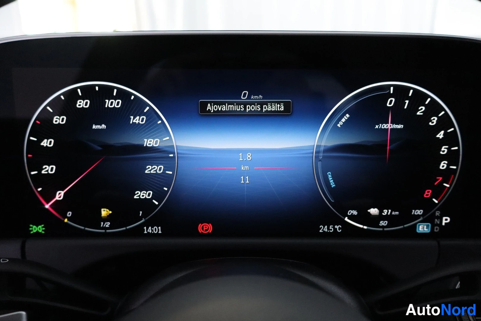 Sivulta: Digital instrument cluster showing speedometer to 260 km/h, power/charge dial, 'Ajovalmius pois päältä' message and 0 km/h