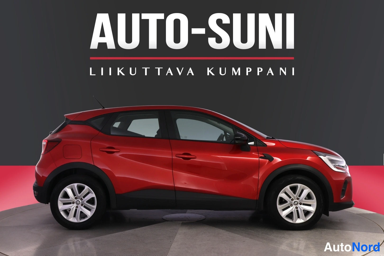 Etuviisto, nokka oikealle: Punainen Renault Captur etukulmasta oikealle, valkoviisteiset alumiinivanteet