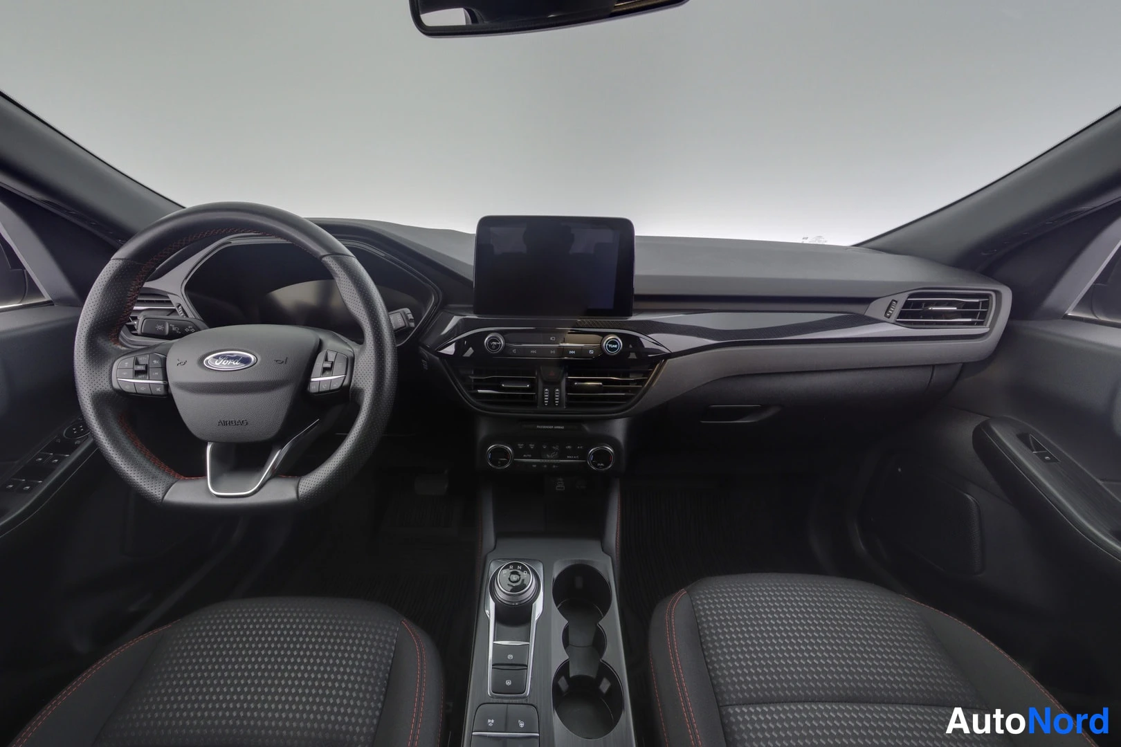 Muu: Auton ohjaamo edestä: Ford-ohjauspyörä, kosketusnäyttö keskikonsolissa, automaattivaihteen keilaratkaisu ja kupinpitimet.