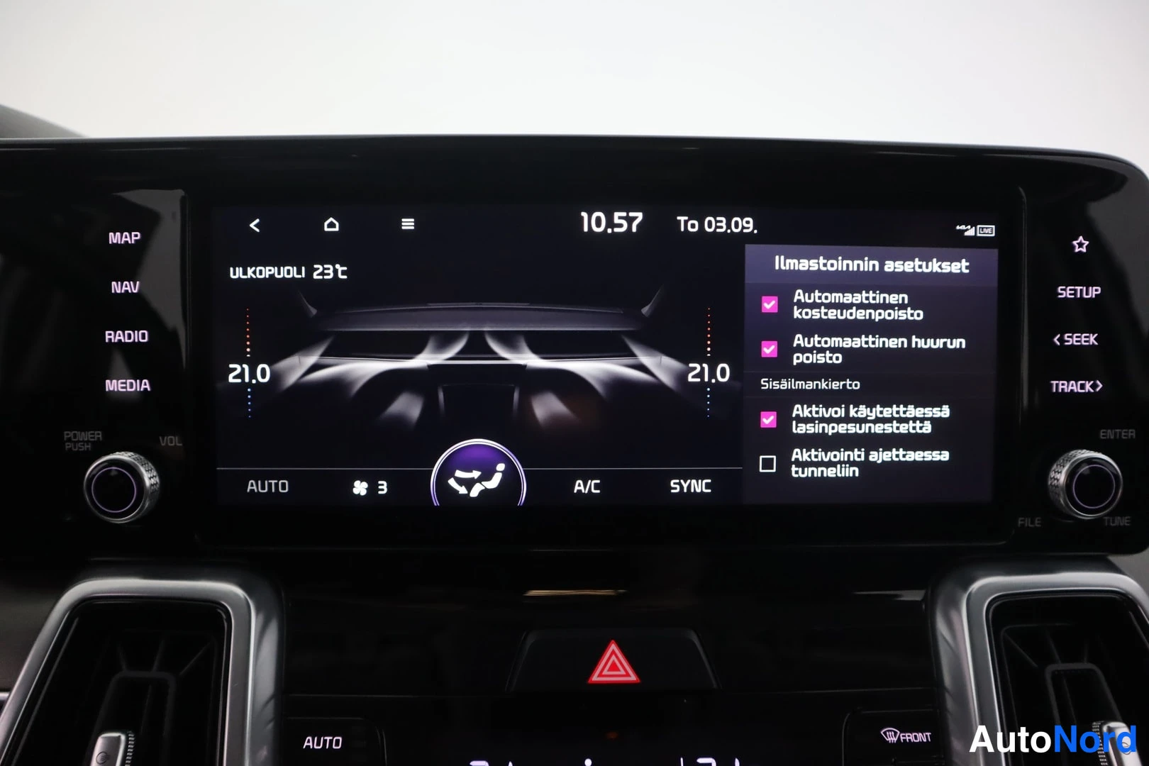 Muu: Ilmastoinnin asetukset -näkymä, jossa ulkolämpötila 23 °C, molempien puolten lämpötila 21,0, AUTO ja A/C aktiivisina sekä valikossa automaattinen kosteudenpoist