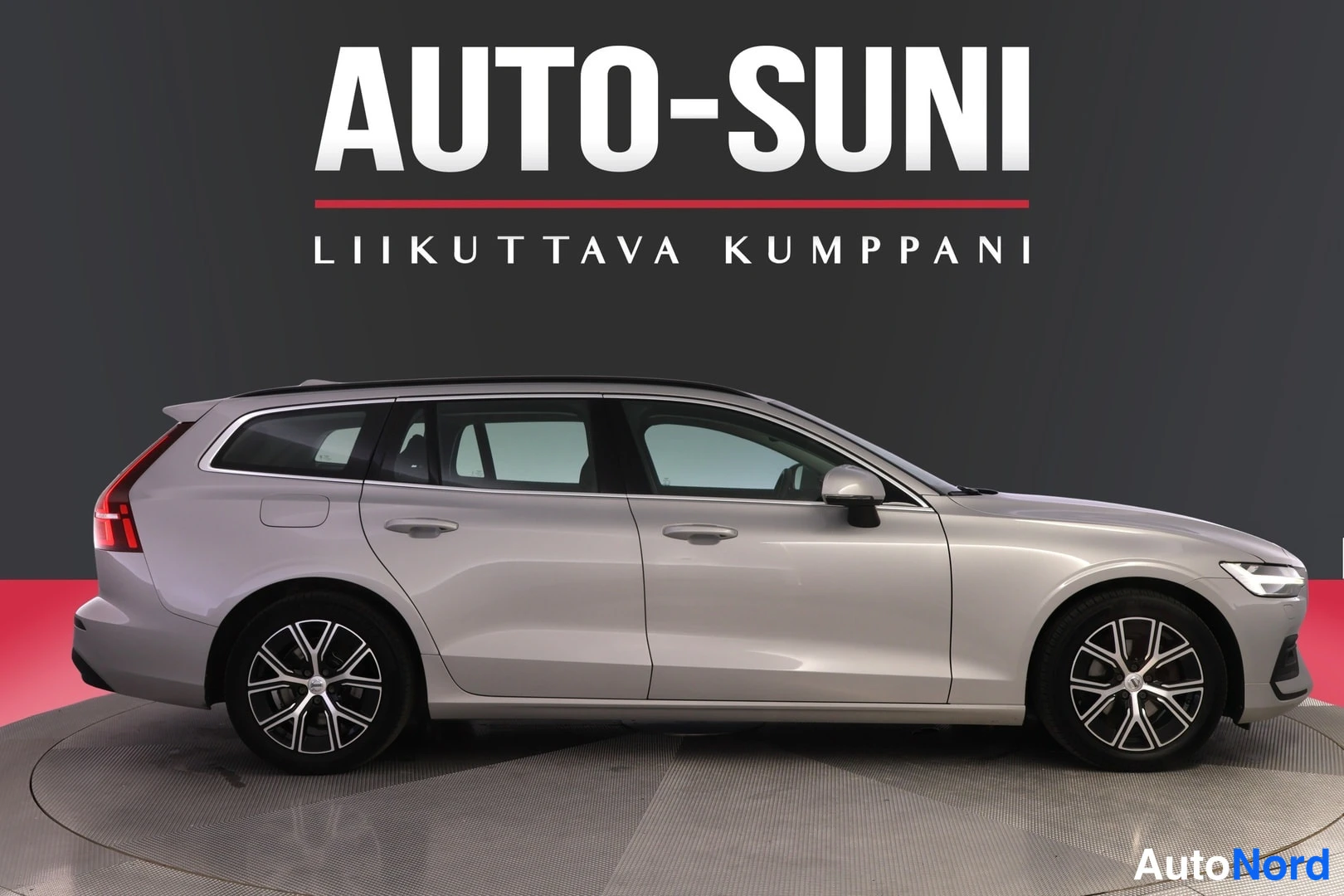Sivulta: Auton vasen sivu suoraan sivulta; hopeanharmaa farmariauto.