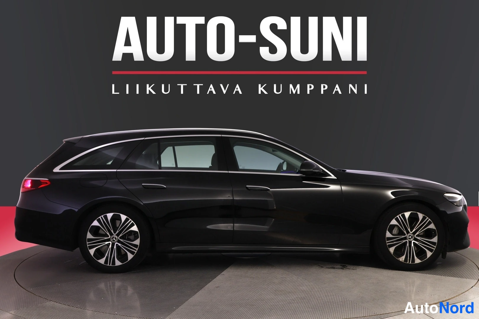 Sivulta: Musta Mercedes-Benz farmariauto studiotapaamisessa, kylkinäkymä.