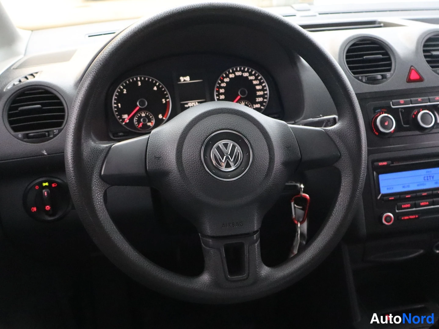 Edestä: Ohjaamo suoraan edestä: VOLKSWAGEN-mallin ohjauspyörä, takana mittaristo ja center-konsolissa RCD 310 -radio.
