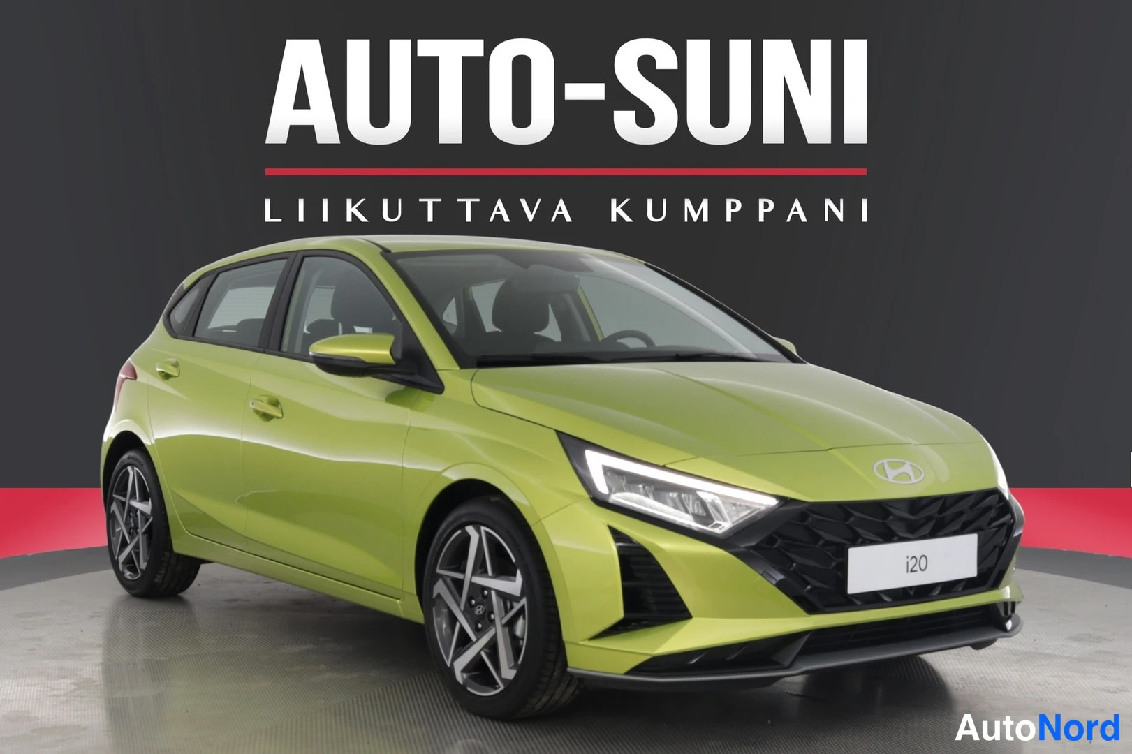 Etuviisto, nokka oikealle: Vihränkeltainen Hyundai i20 -viistotakaa edestä oikealta, kylki ja keula näkyvissä studiotaustaa vasten.
