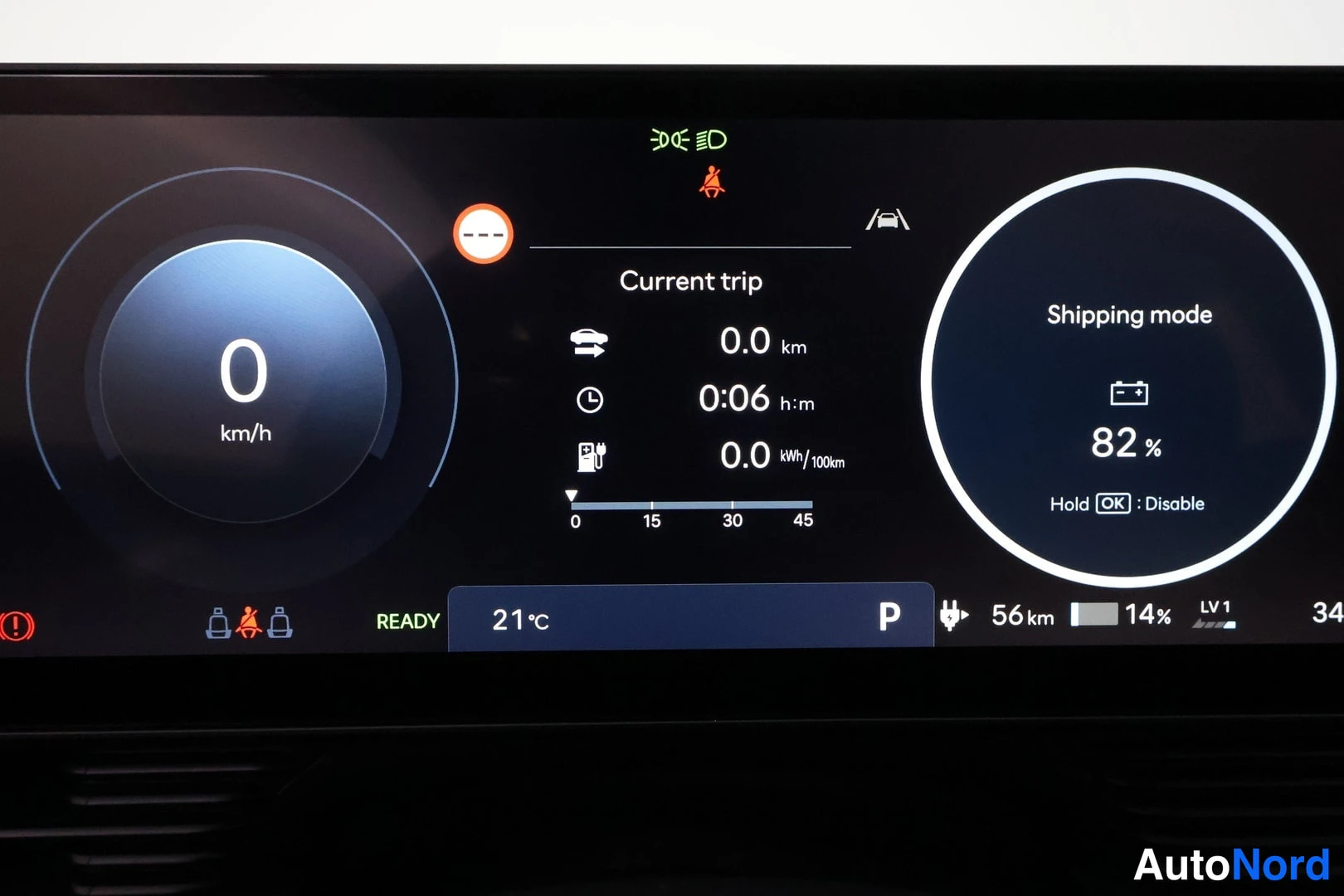 Ohjaamo: Digital instrument cluster displaying the vehicle at 0 km/h. A message on the right indicates Shipping mode is active with the battery at 82%. Trip information