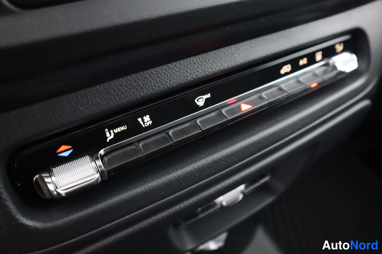 Yksityiskohta: Close-up view of the climate control panel. Controls include a temperature slider knob, MENU button, OFF button with fan icon, MAX button with defrost symbol, a