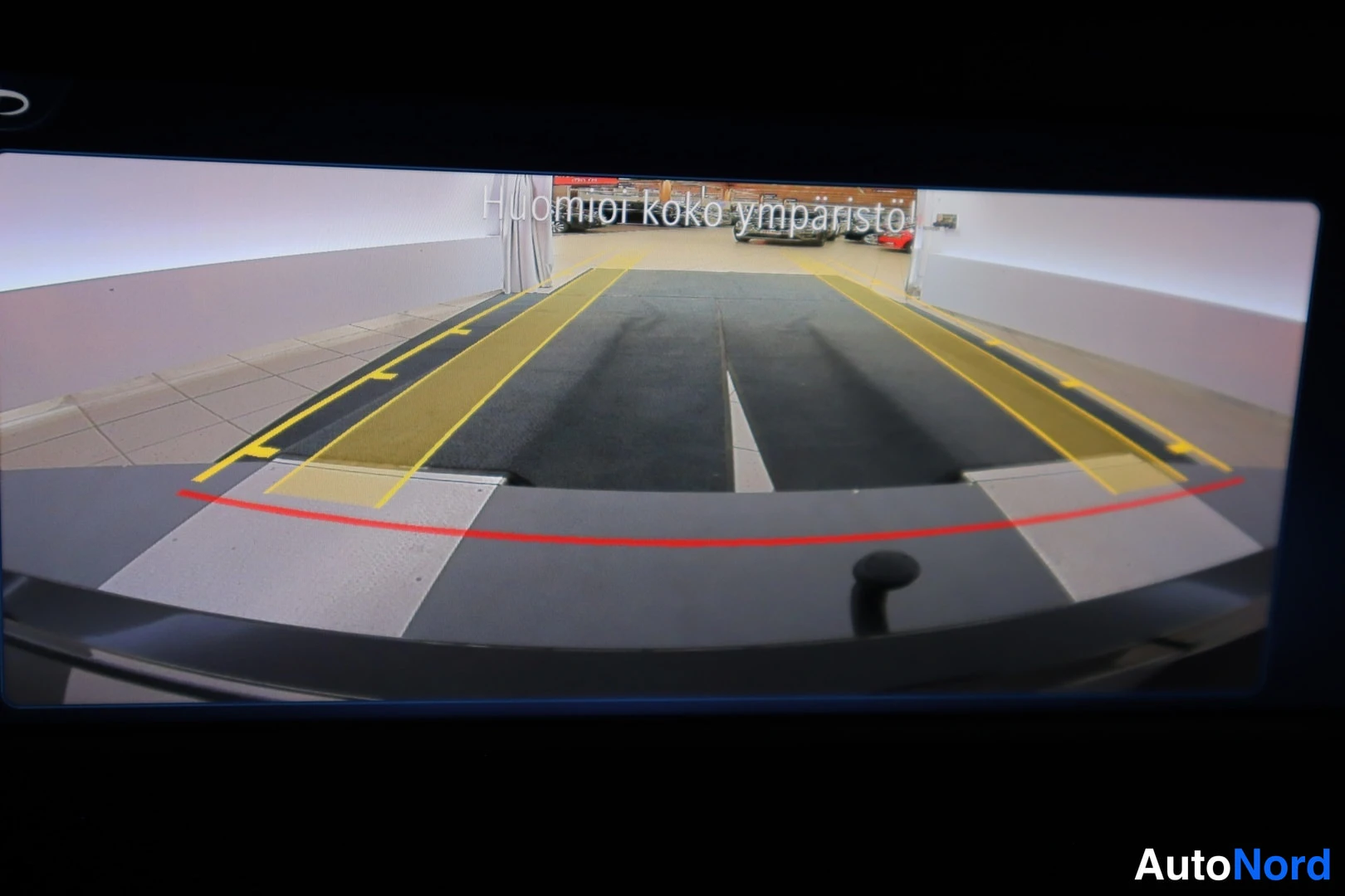 Muu: Infotainment-näytöllä 360-asteinen ympäristönäkymä tekstillä 'Huomioi koko ympäristö'.