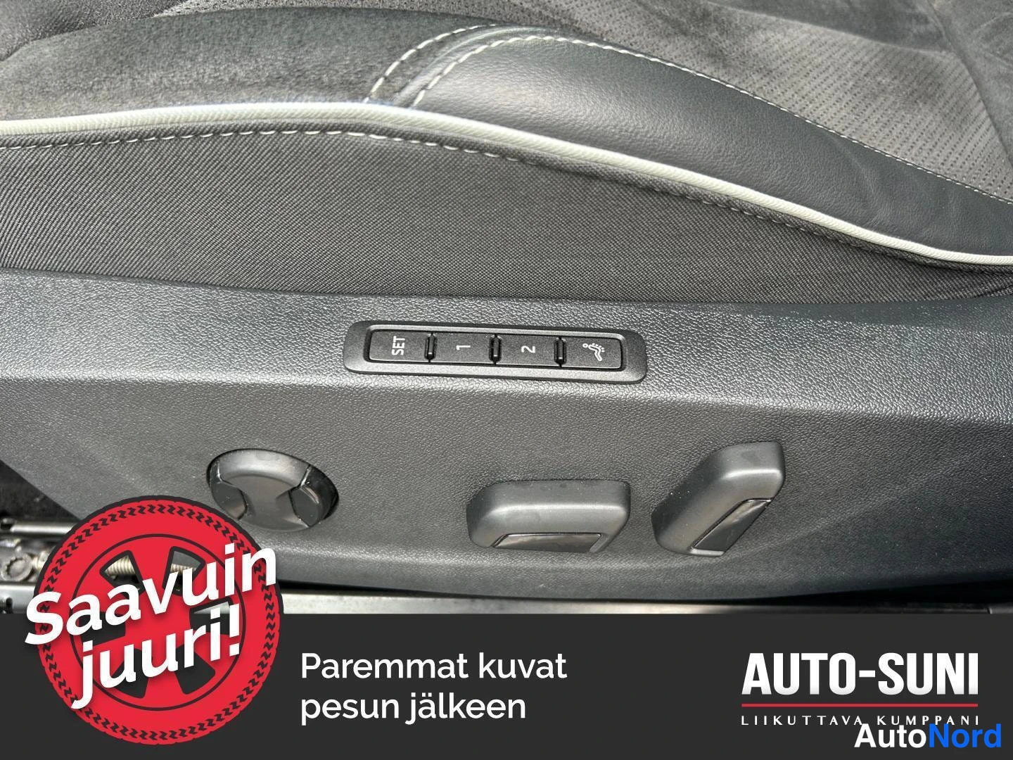 Etuistuimet: Close-up view of the driver's seat side bolster showing electronic adjustment controls labeled SET, 1, and 2, along with memory function switches.