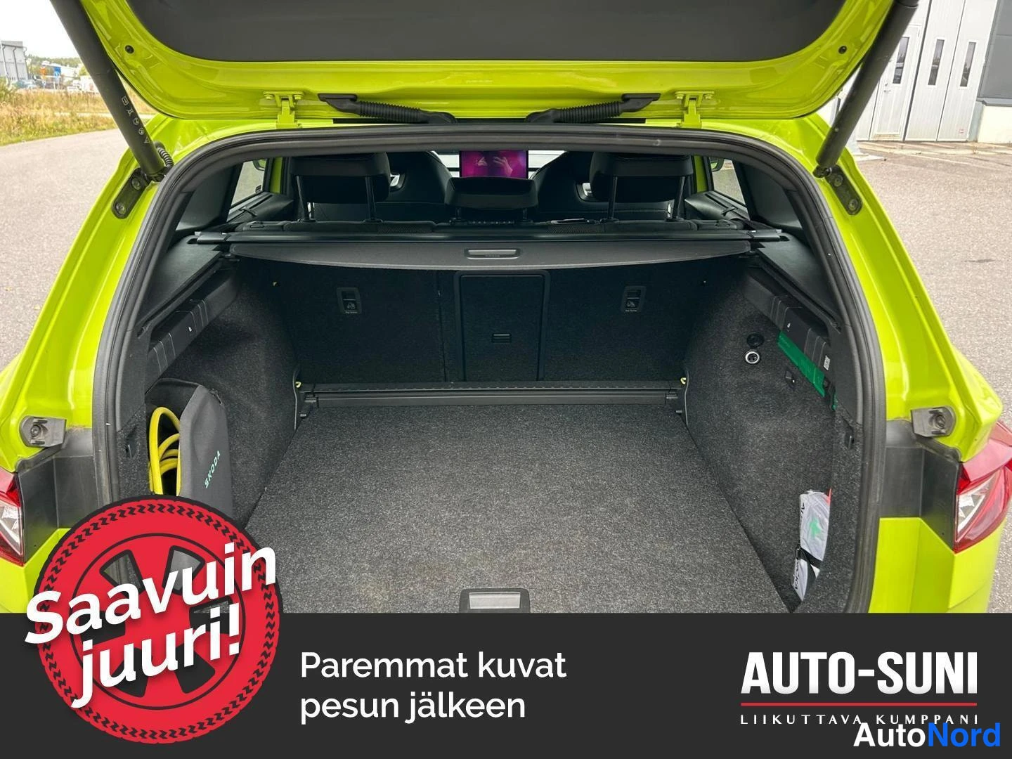 Muu: A green Skoda Enyaq with the rear hatch open, showing a spacious boot area.