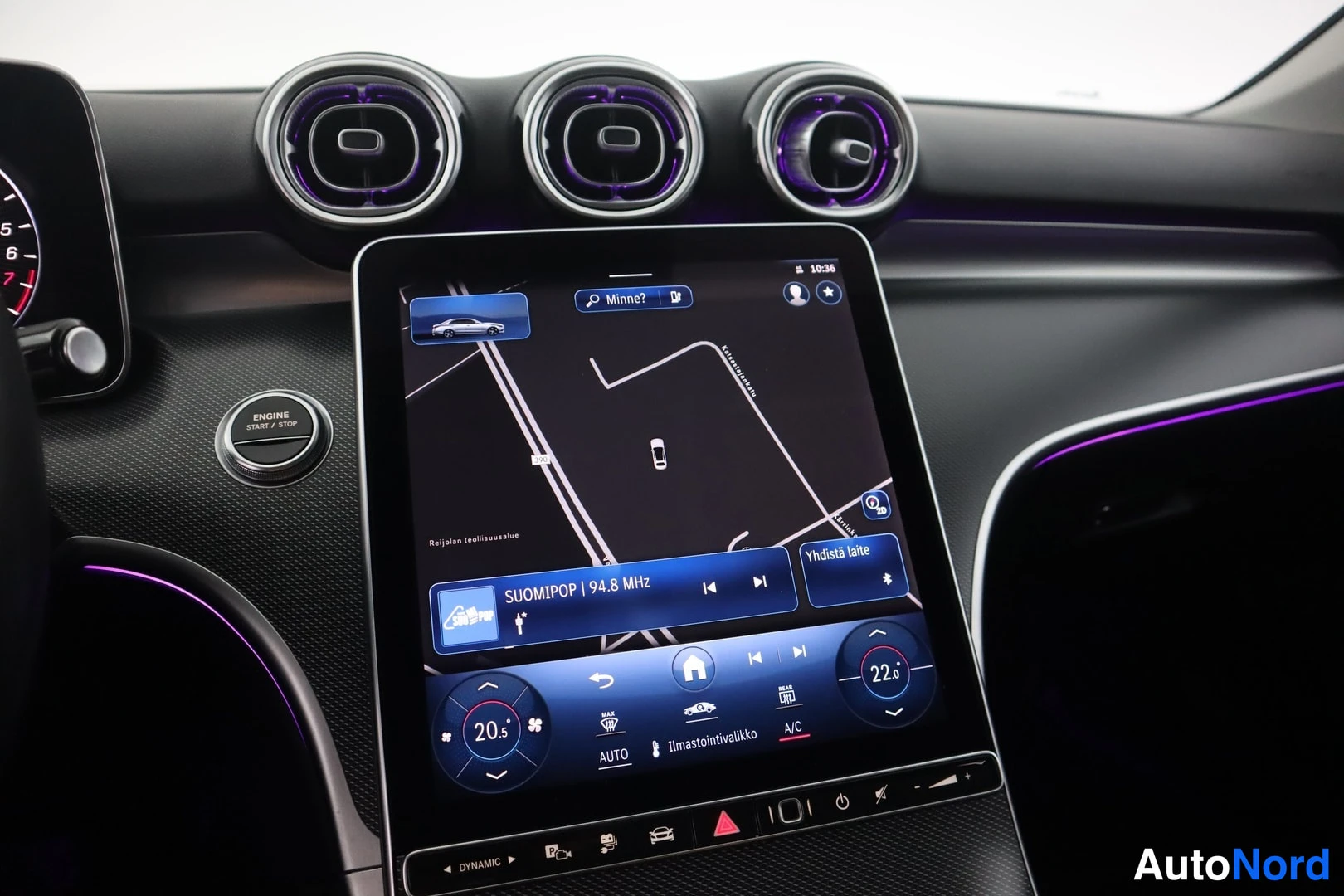Muu: Close-up of the infotainment screen showing 'Ilmastointivalikko' (Climate menu) and an 'ENGINE START / STOP' button to the left. Air vents are visible at the to