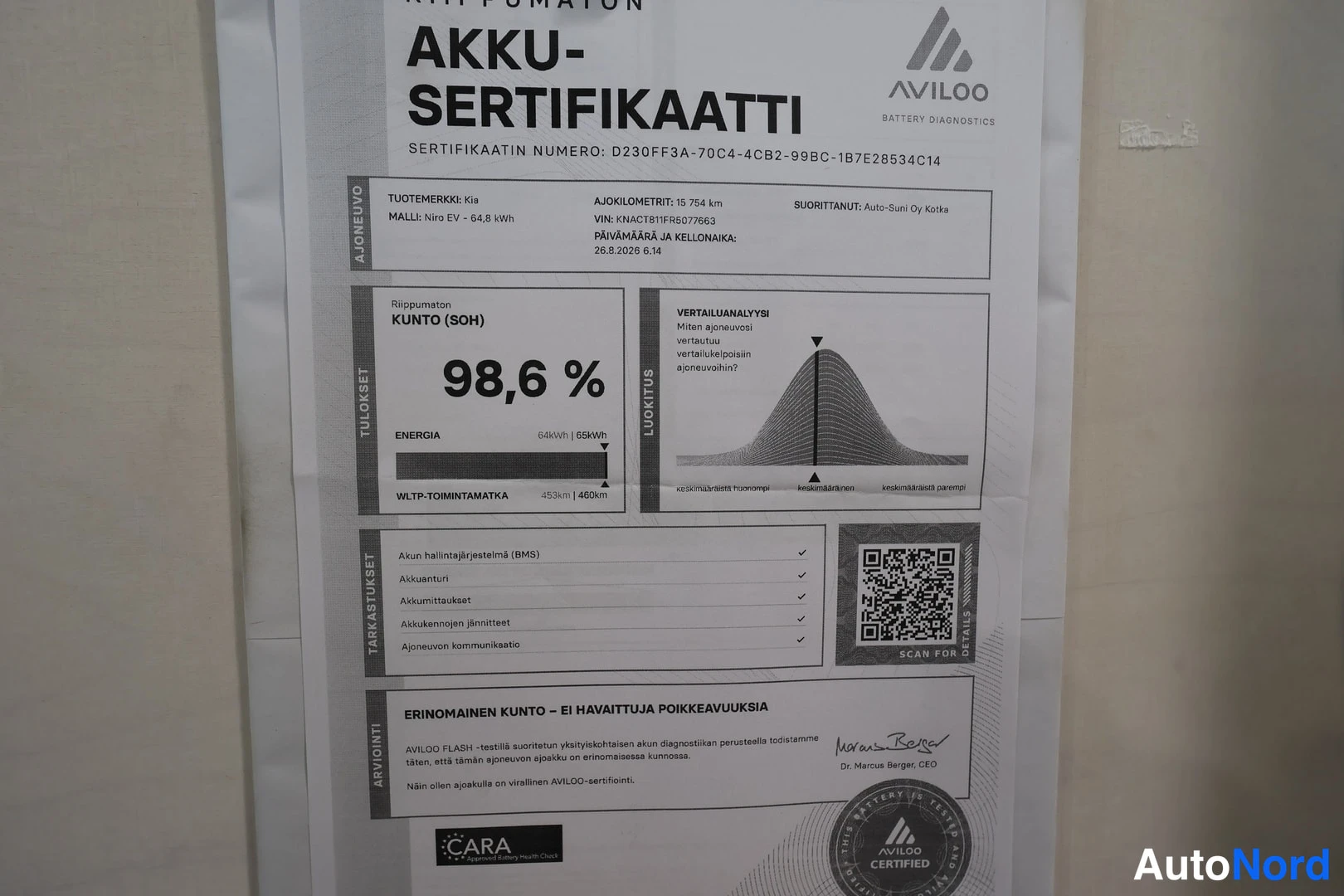 Asiakirja: Close-up of an Avilo battery certificate document showing a health percentage of 98.6%.