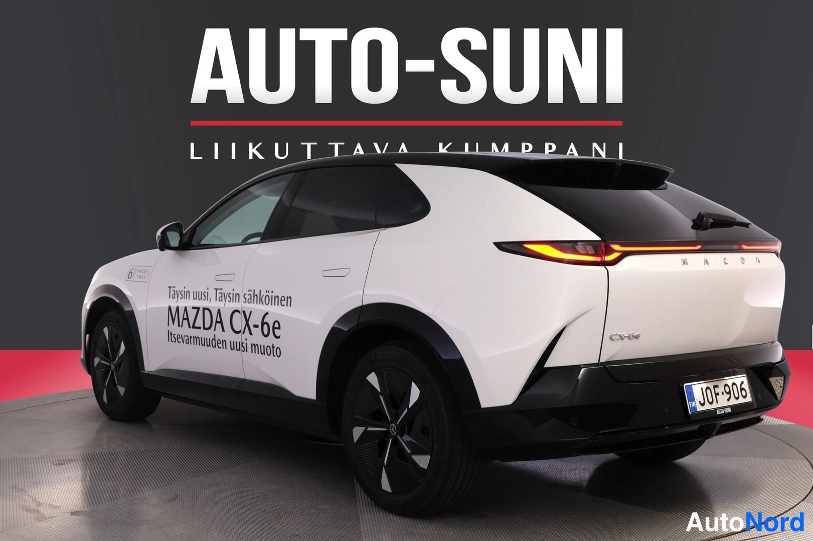 Takaviisto: Valkoinen Mazda CX-6e -porrasperä takakulmasta, perä oikealla, tunnus