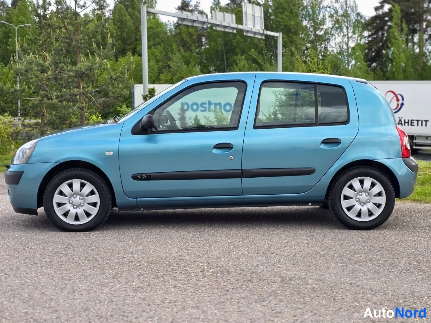 Sivulta: Sivunäkymä sinisestä Renault Clio -viistoperästä.