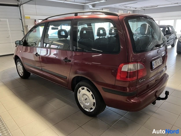 Takaviisto: Tummanpunaisen Ford Galaxyn takakulman nauhoite: takaosa ja vasen kylki näkyvillä, takavalo, kolarsi ja vetokoukku erottuvat sisätiloissa.