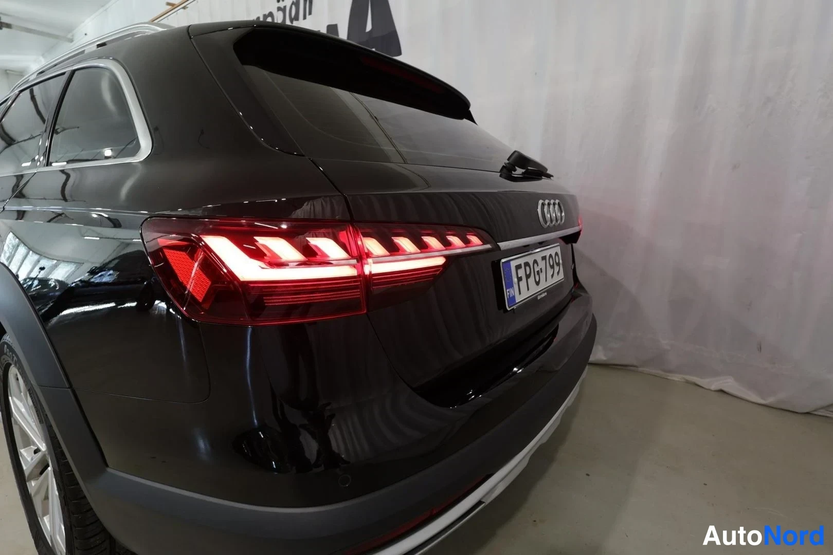 Takaviisto: Mustan farmariauton takaosa ja vasen kylki neljäsosan takakulmasta; LED-takavalot, Audi-merkki ja rekisterikilpi näkyvät.