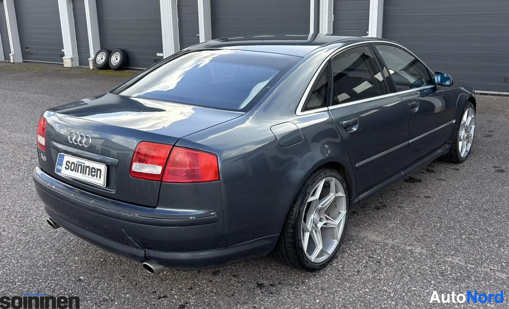 Takaviisto: Tummanharmaa sedan takakulmasta kuvattuna, takavaloja ja A8-merkki näkyvät.