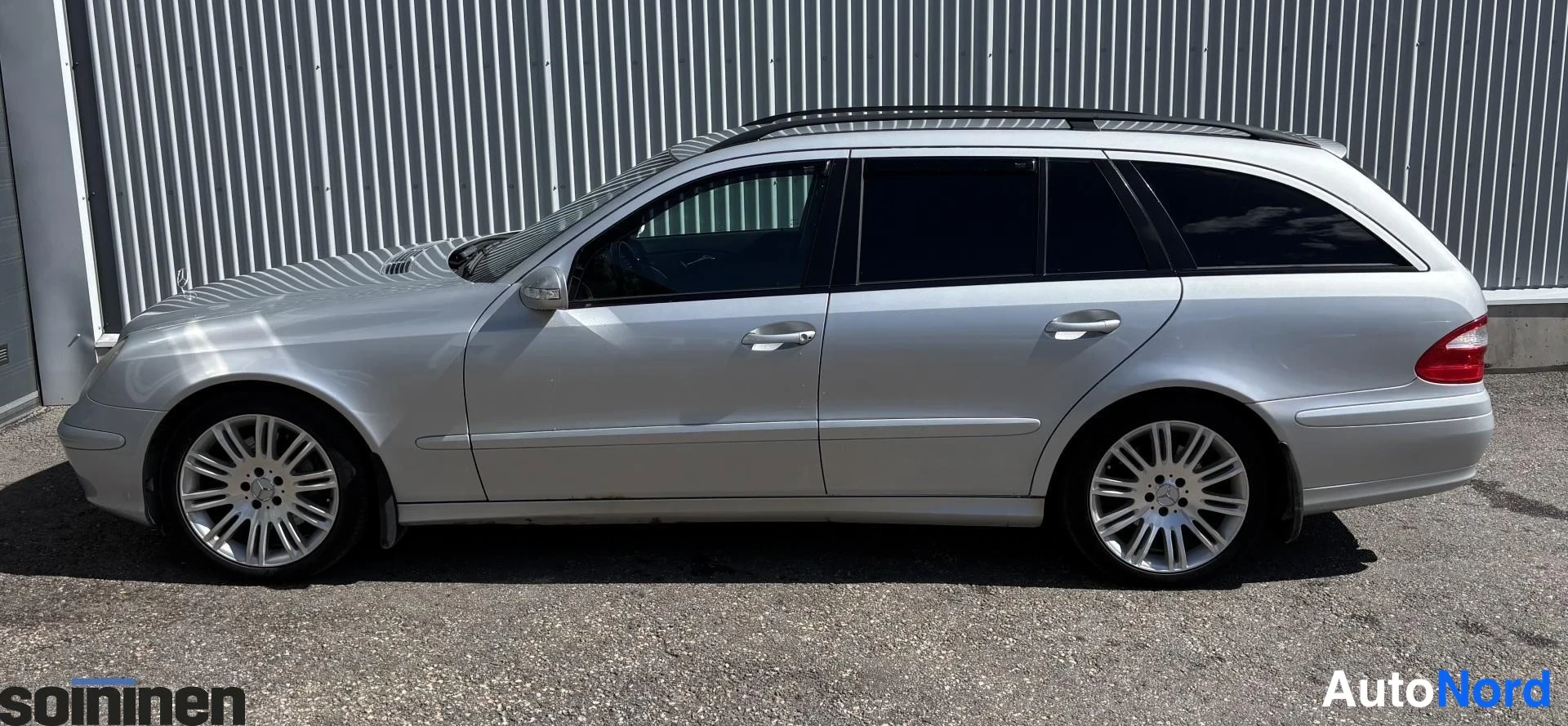 Sivulta: Hopeanväräinen Mercedes-Benz E-farmari sivusta kuvattuna