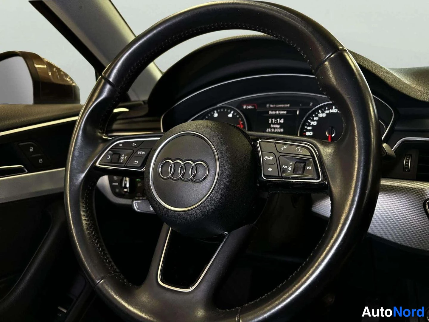 Yksityiskohta: Ohjauspyörä Audi-merkillä ja kokonaan digitaalinen mittaristo.