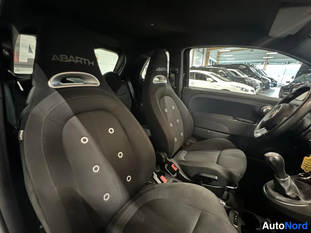 Muu: Auton sisätilat: mustat ABARTH-merkkiset urheiluistuimet, rattin ja vaihteenvalitsin osin näkyvissä.
