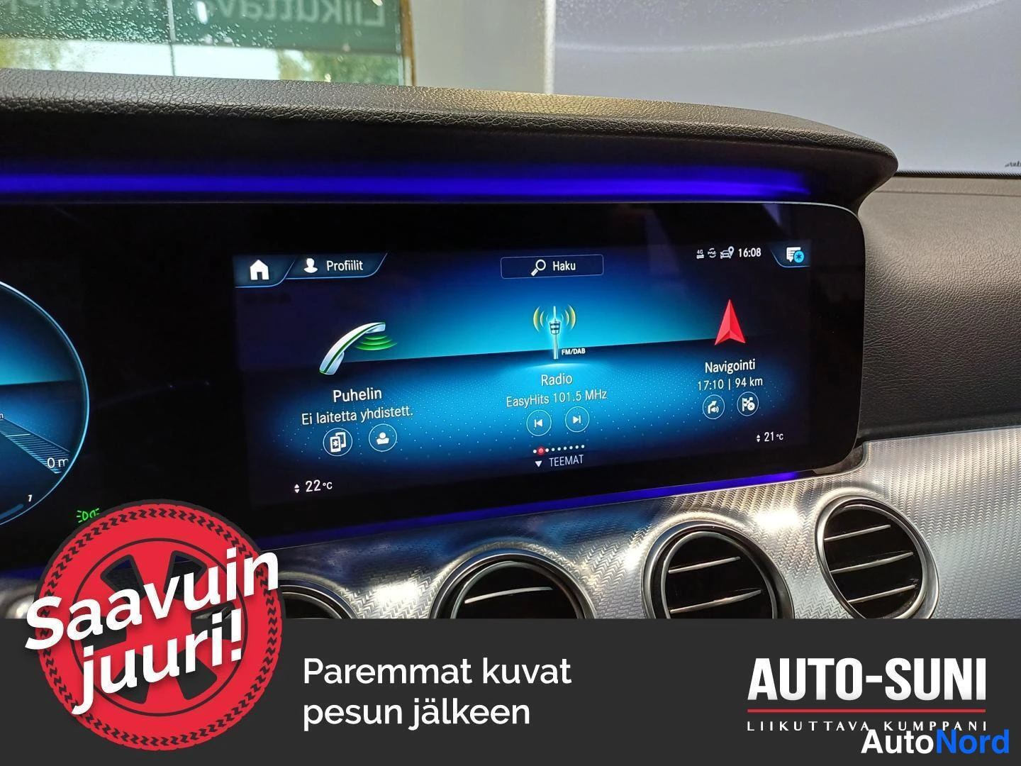 Muu: Auton kojelaudan näyttö, jossa puhelin-, radio- ja navigointivalikot; ilmastointiautomaatin ilmastointisäätimet ja pyöreät ilmastointiautomaatin ilmastointisuut