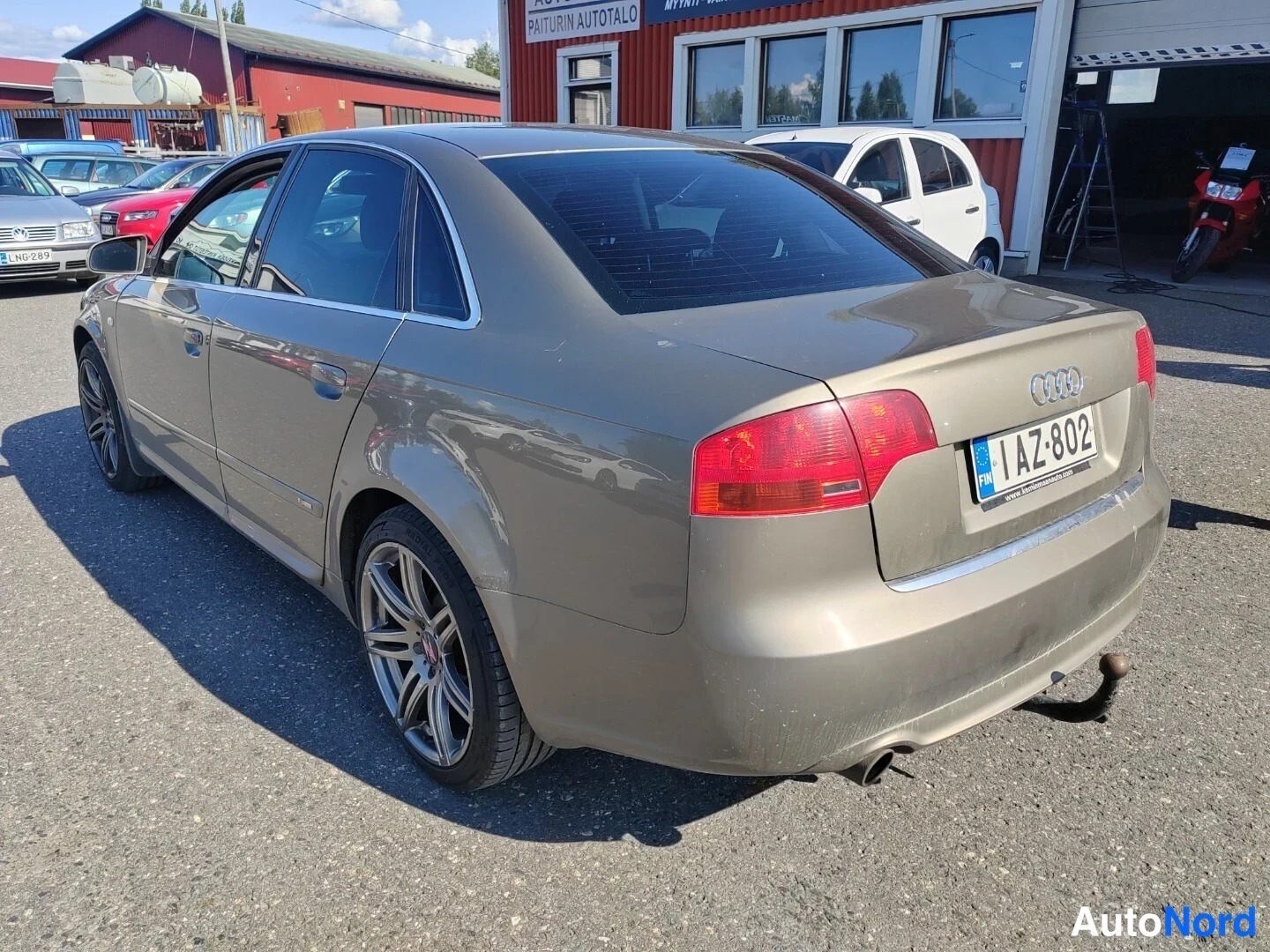 Takaviisto: Auton takakulmakuva ulkona; rekisterikilpi AZ-802, perävaunukoukku näkyy.