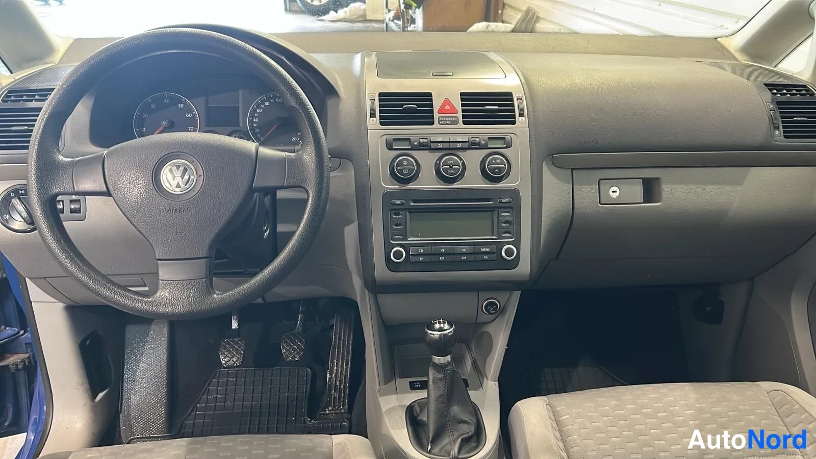 Muu: Kojelauta etualalta: VW-ohjauspyörä, mittaristo, radio-yksikkö näytöllä ja CD-lähteenä, kolme pyöreää ilmastointisäädintä, manuaalivaihtajan kuppi ja kytkin/jar