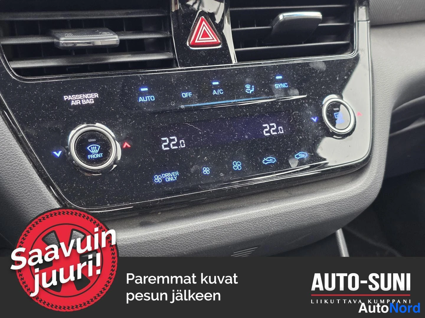 Yksityiskohta: Ilmastointipaneelin lähikuva: automaattinen kaksipiirinen ilmastointi, lämpötila 22,0 molemmilla puolilla, napit AUTO, OFF, A/C, SYNC ja DRIVER ONLY.