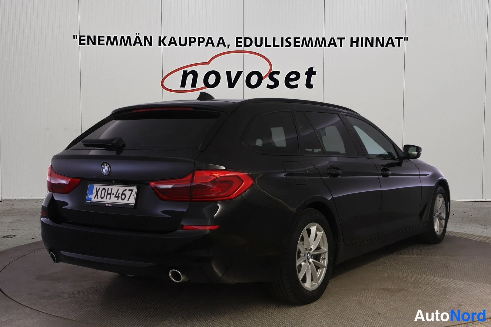 Takaviisto: Rear three-quarter view of a black BMW station wagon from the passenger side angle.