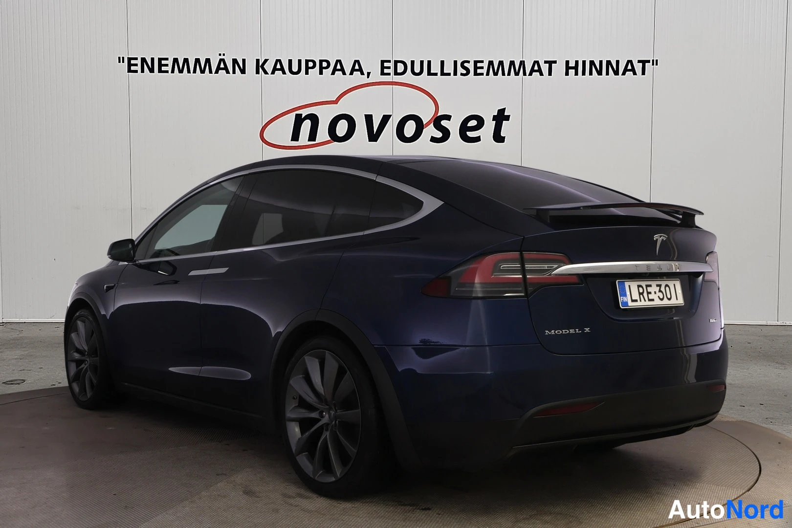 Takaviisto: Tummansininen Tesla Model X takaviistosta, rekisteritunnus ja MODEL X -teksti takaluukussa.