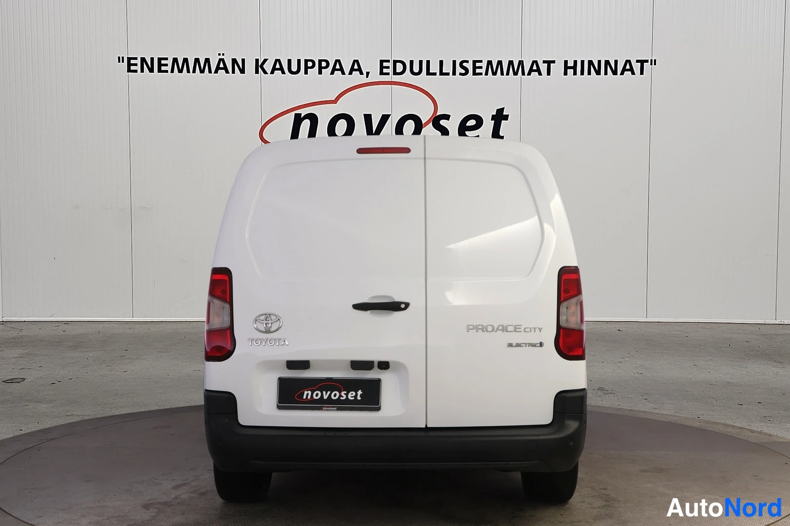 Takaa: Valkoisen Toyota Proace City Electric -pakettiauton takanäkö, takaovet suljettu, PROACE CITY -teksti takapaneelissa.
