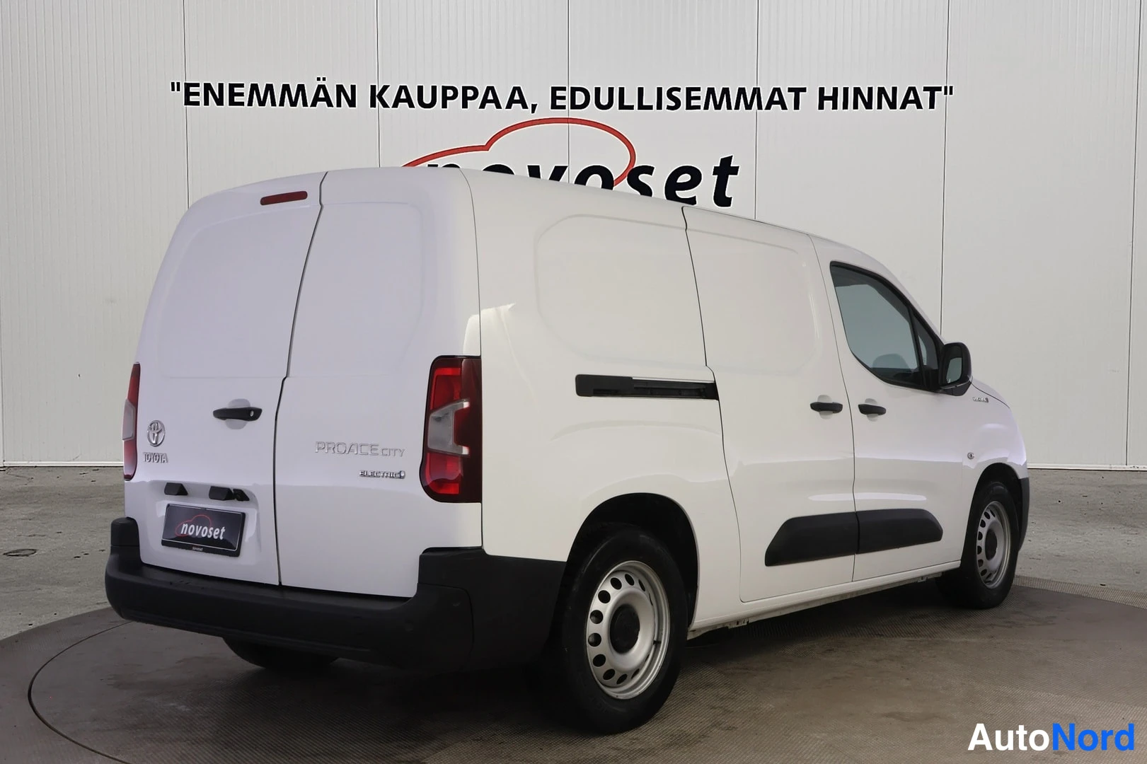 Takaviisto: Valkoinen Toyota Proace City -pakettiauto takaa sivulta, liukuovi ja takapaneeli näkyvissä.
