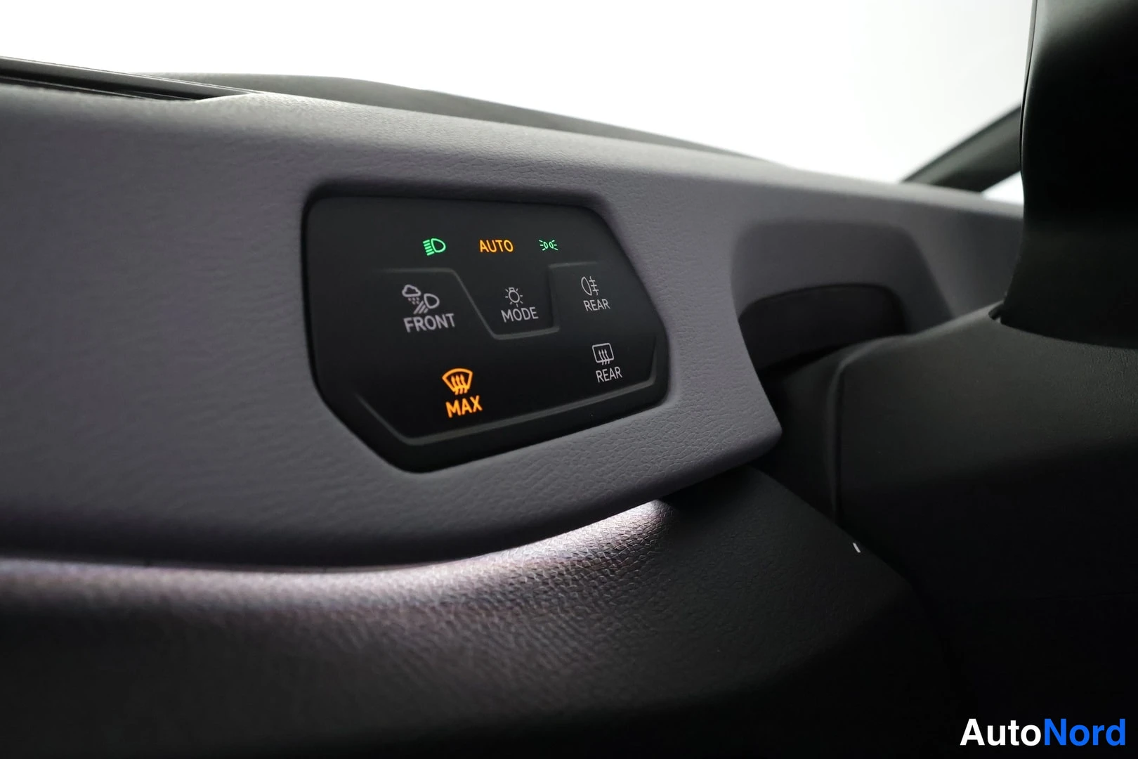 Yksityiskohta: Sisäkuva: kojelaudan paneeli, jossa merkkivalot AUTO ja MAX sekä näppäimet FRONT, MODE ja REAR.
