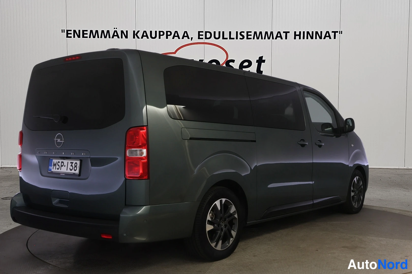 Takaviisto: Auton takakulma vasemmalta, tummanharmaa pakettiauto, rekisterikilpi