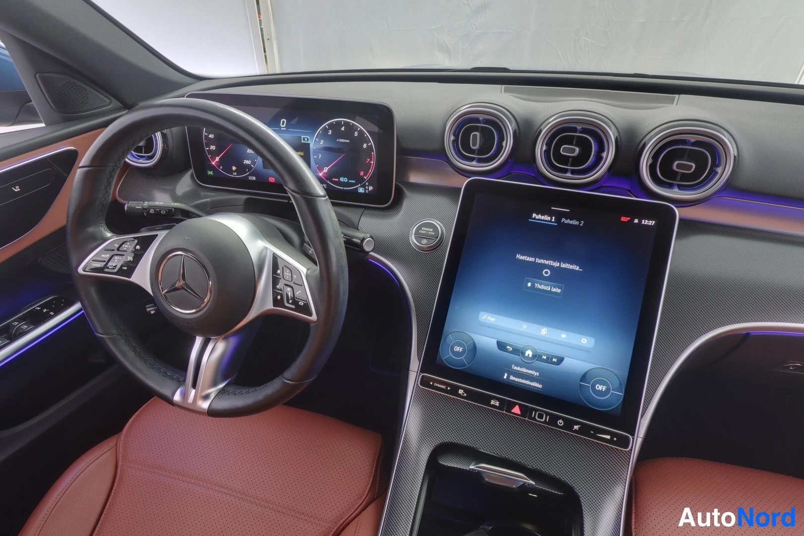 Muu: Close-up view of the driver's side interior focusing on the multifunction steering wheel with buttons, digital instrument panel, and the upper portion of the ce