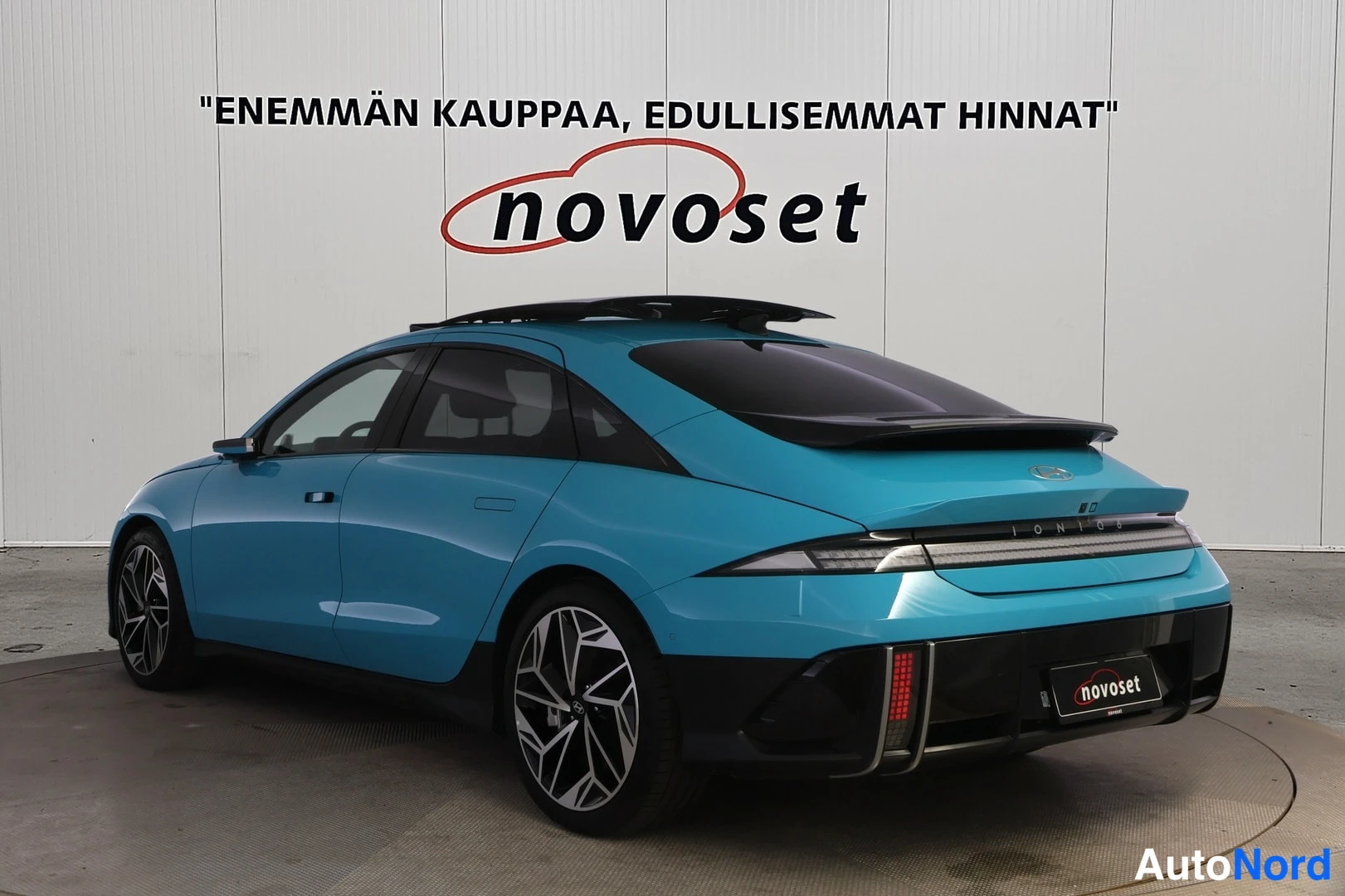 Takaviisto: Turkoosi Hyundai Ioniq 6 takaviistosta; pitkä poikittainen takavalojiirto, IONIQ 6 -teksti ja harmaat kevytmetallivanteet näkyvissä.