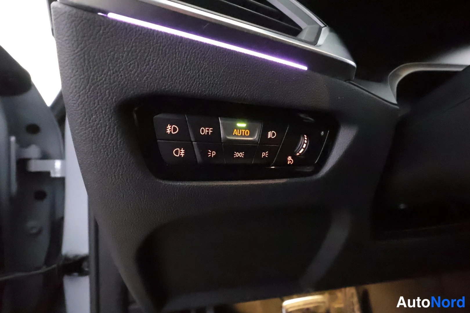 Muu: Lähikuva kojetaulun valokytkinryhmästä, jossa AUTO-merkki valaistuna.