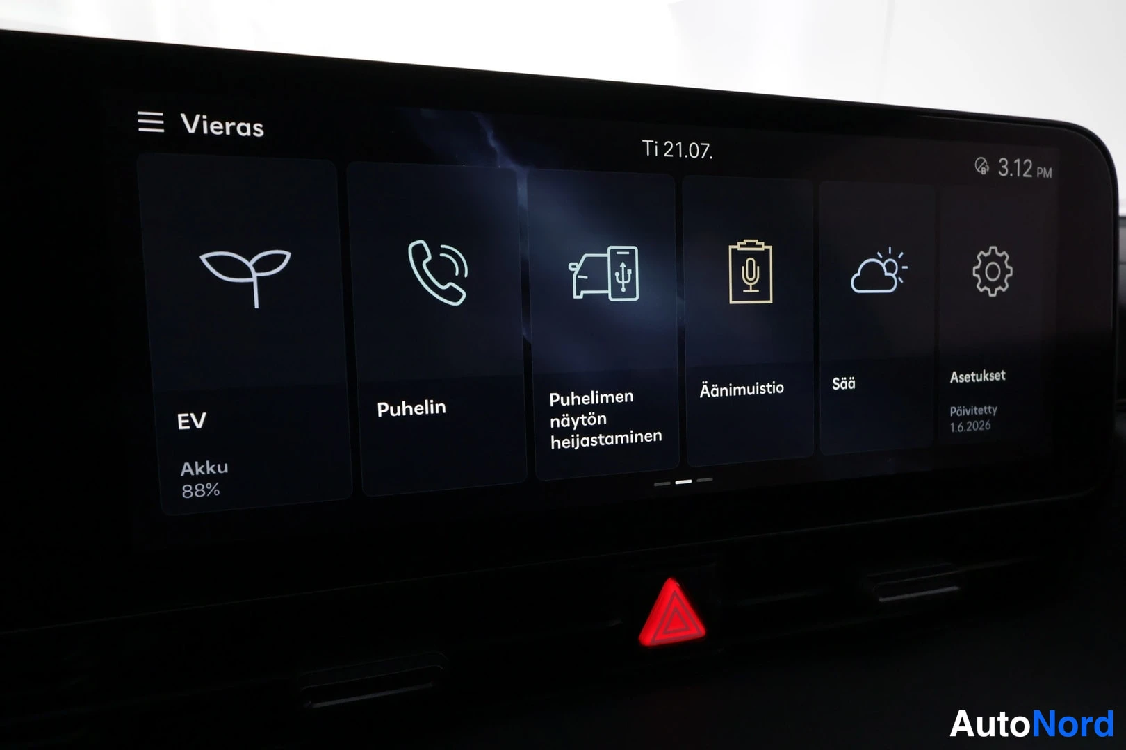 Yksityiskohta: Infotainment-näytön aloitusnäkymä sovelluskuvakkeilla EV (Akku 88 %), Puhelin, Puhelimen näytön heijastaminen, Äänimulistio, Sää ja Asetukset, yläreunassa Ti 21