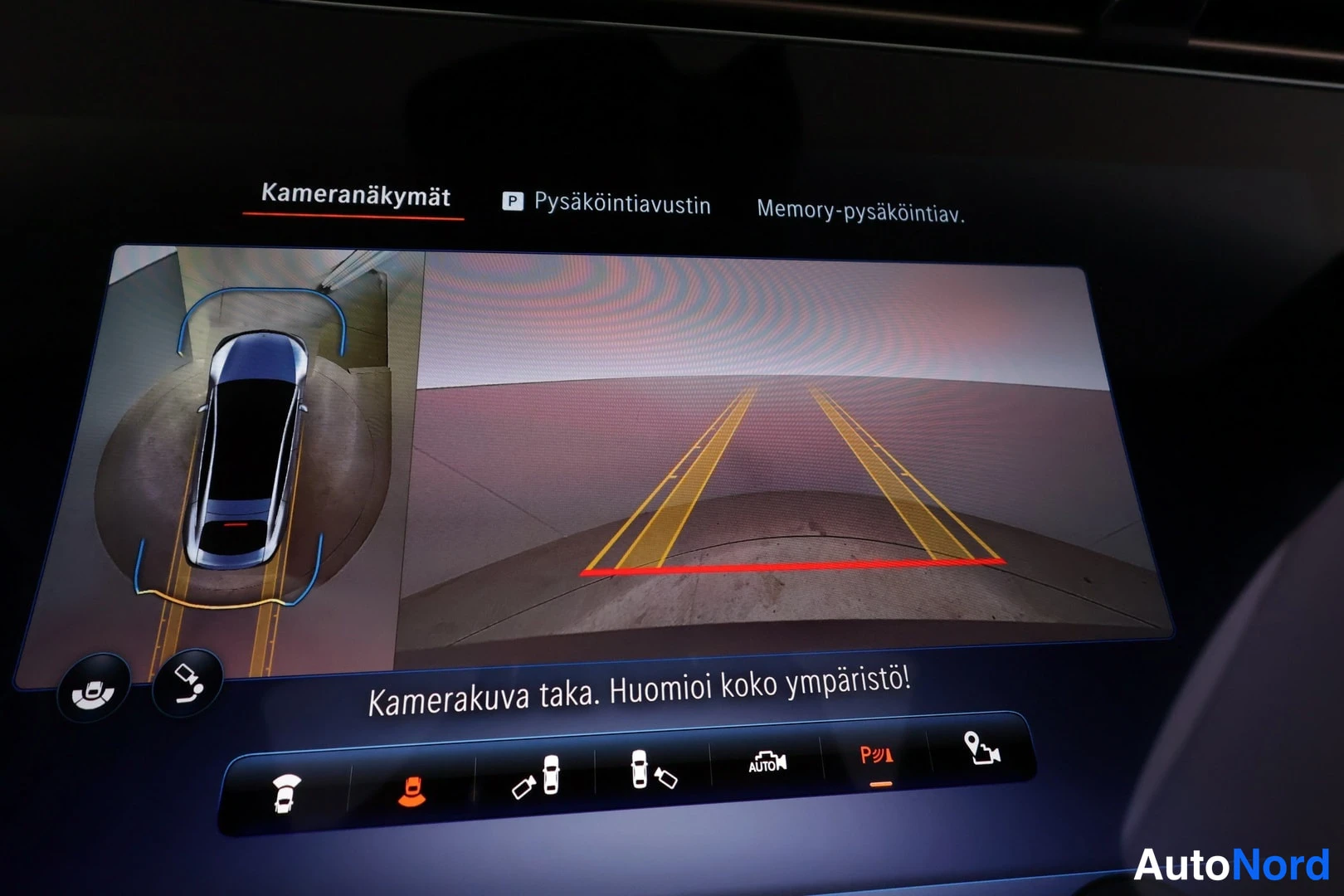 Muu: Auton infotainment-näyttö näyttää Kameranäkymät-valikon pysäköintikameralla, 360-asteen ympäristönäkymällä ja tekstillä Kamerakuva taka. Huomioi koko ympäristö!