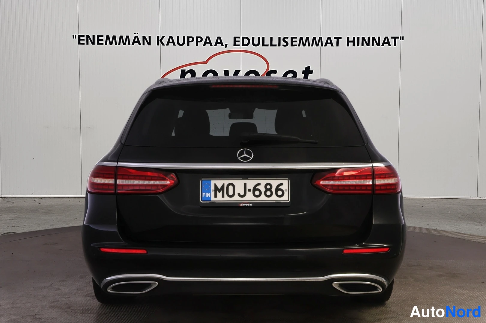 Takaa: Mercedes-Benz E 200 d -farmari suoraan takaa mustana, rekisterikilpi.