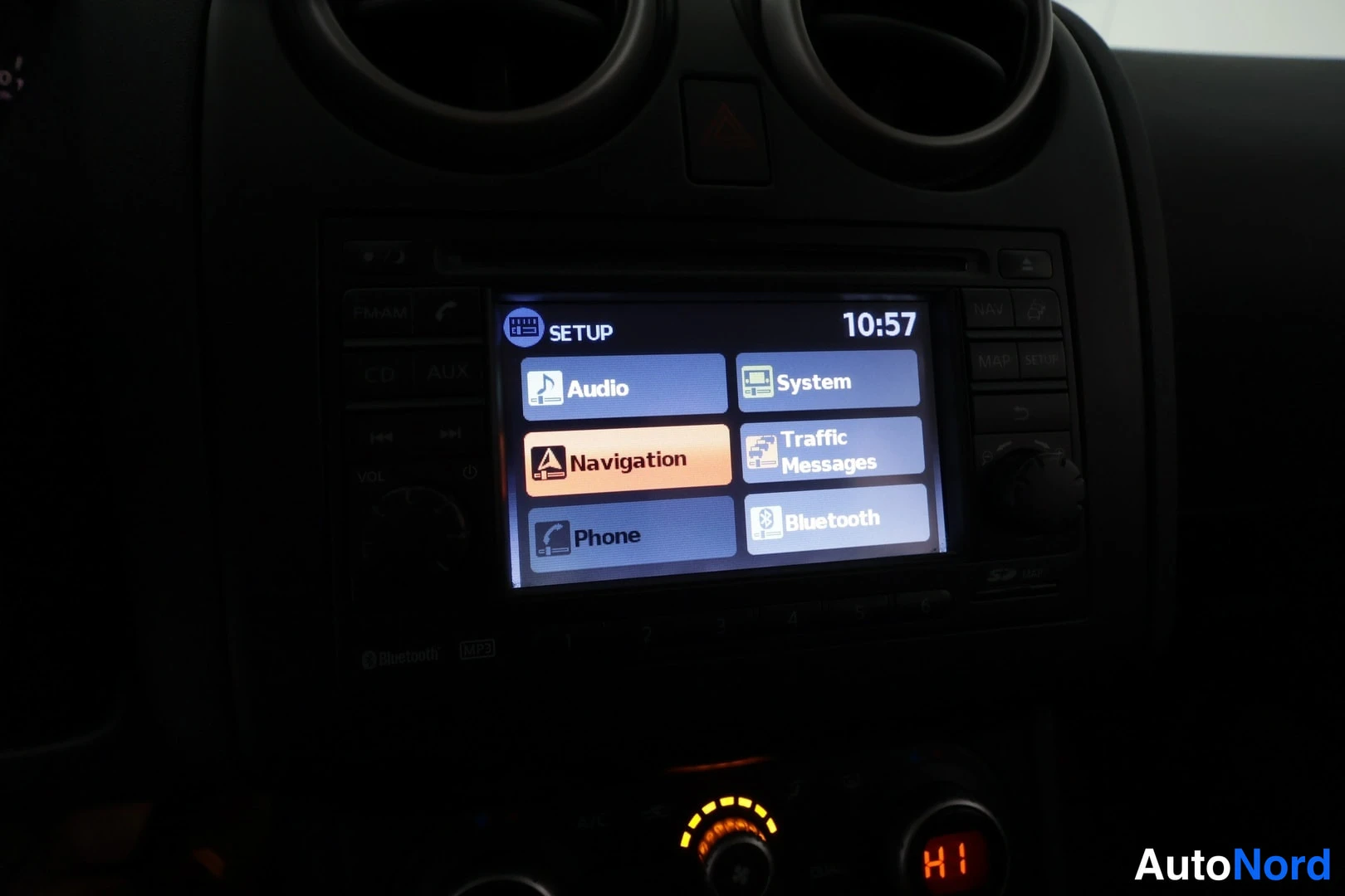Muu: Kojelaudan infotainment-näyttö SETUP-valikossa (Audio, System, Navigation, Traffic Messages, Phone, Bluetooth), kellonaika 10:57.