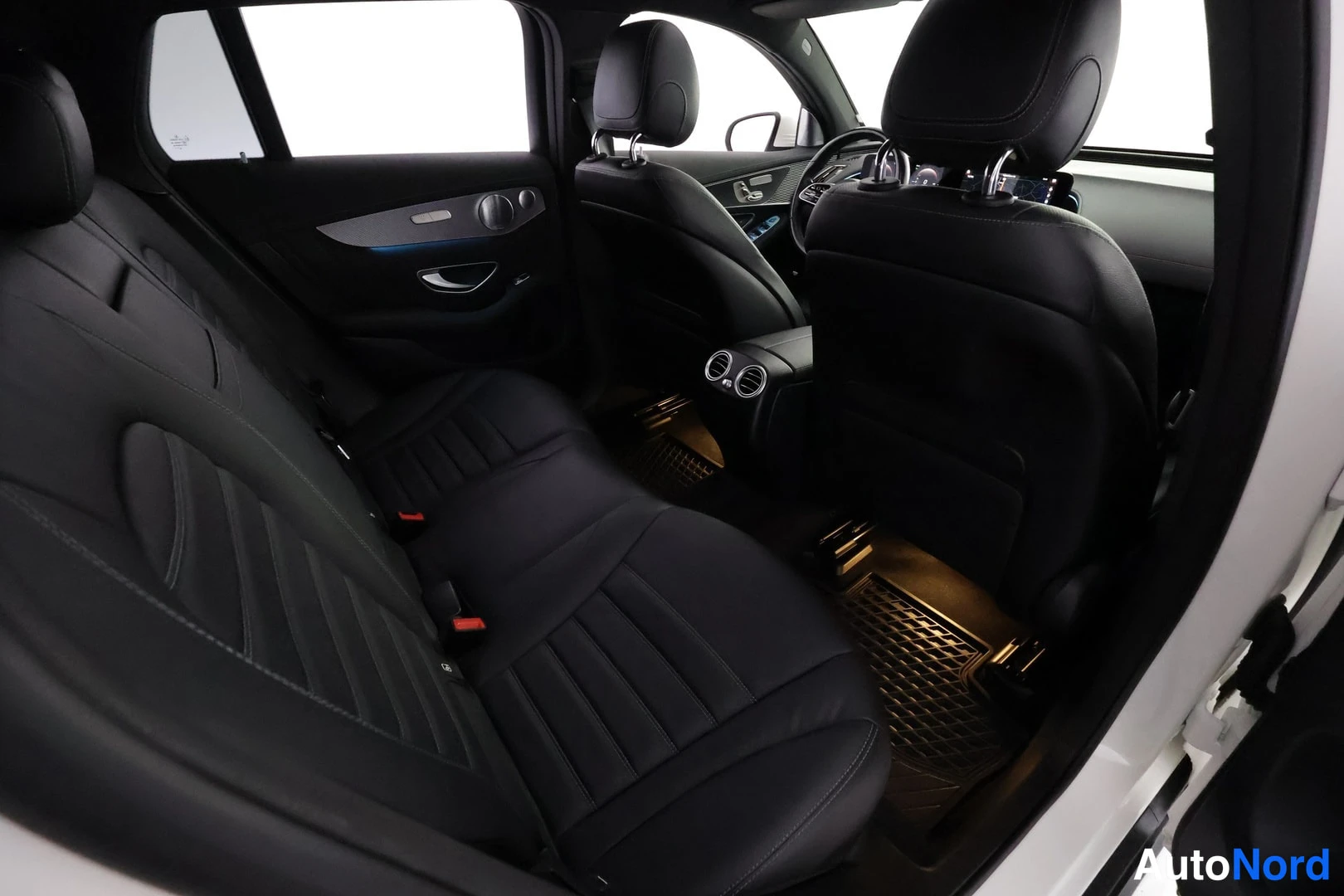 Muu: Musta nahkapäällysteinen takaistuin ja etumatkustajan istuin Mercedes-Benz EQC 400 4MATIC AMG Line 2021 sisätiloissa, takaa avoin ovi ja takajalkatila näkyvät.
