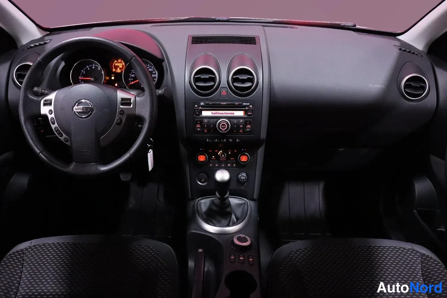 Muu: Kojetaulu keskikädestä: Nissan-ohjauspyörä, käsivaihtoejero, radio- ja ilmastointipaneelit.