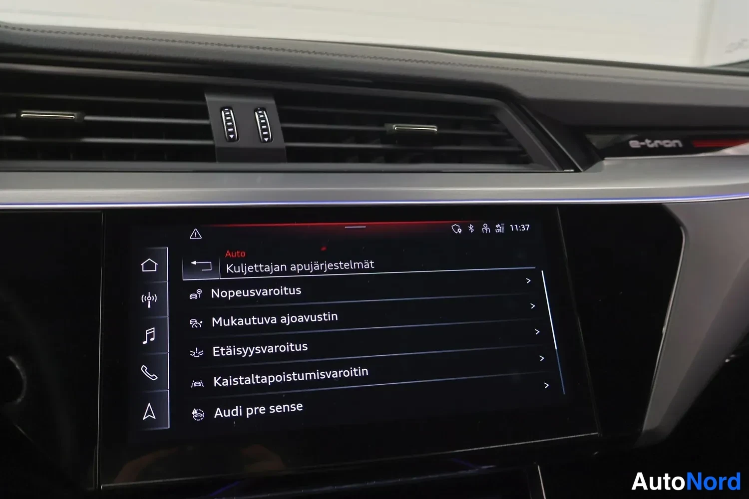 Muu: Audi e-tronin kojelaudan keskinäytös näyttää kuljettajan apujärjestelmien valikon, jossa ovat nopeusvaroitus, mukautuva ajoavustin, etäisyysvaroitus, kaistalta-